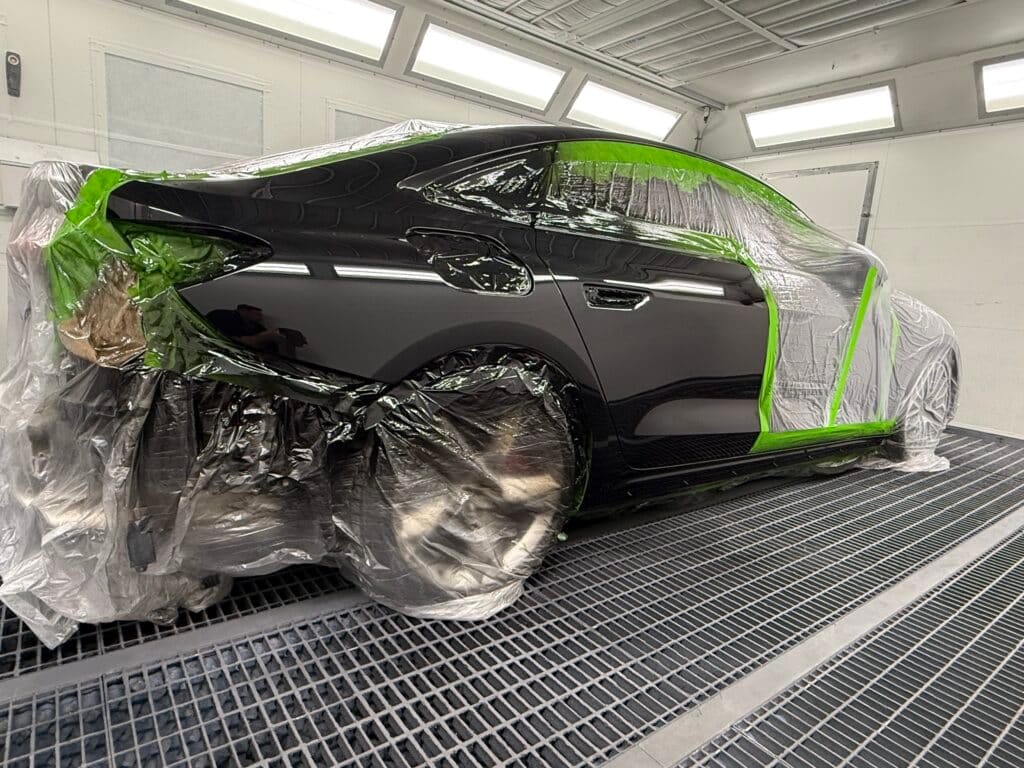 Technician inspecting a vehicle during the smash repair process.