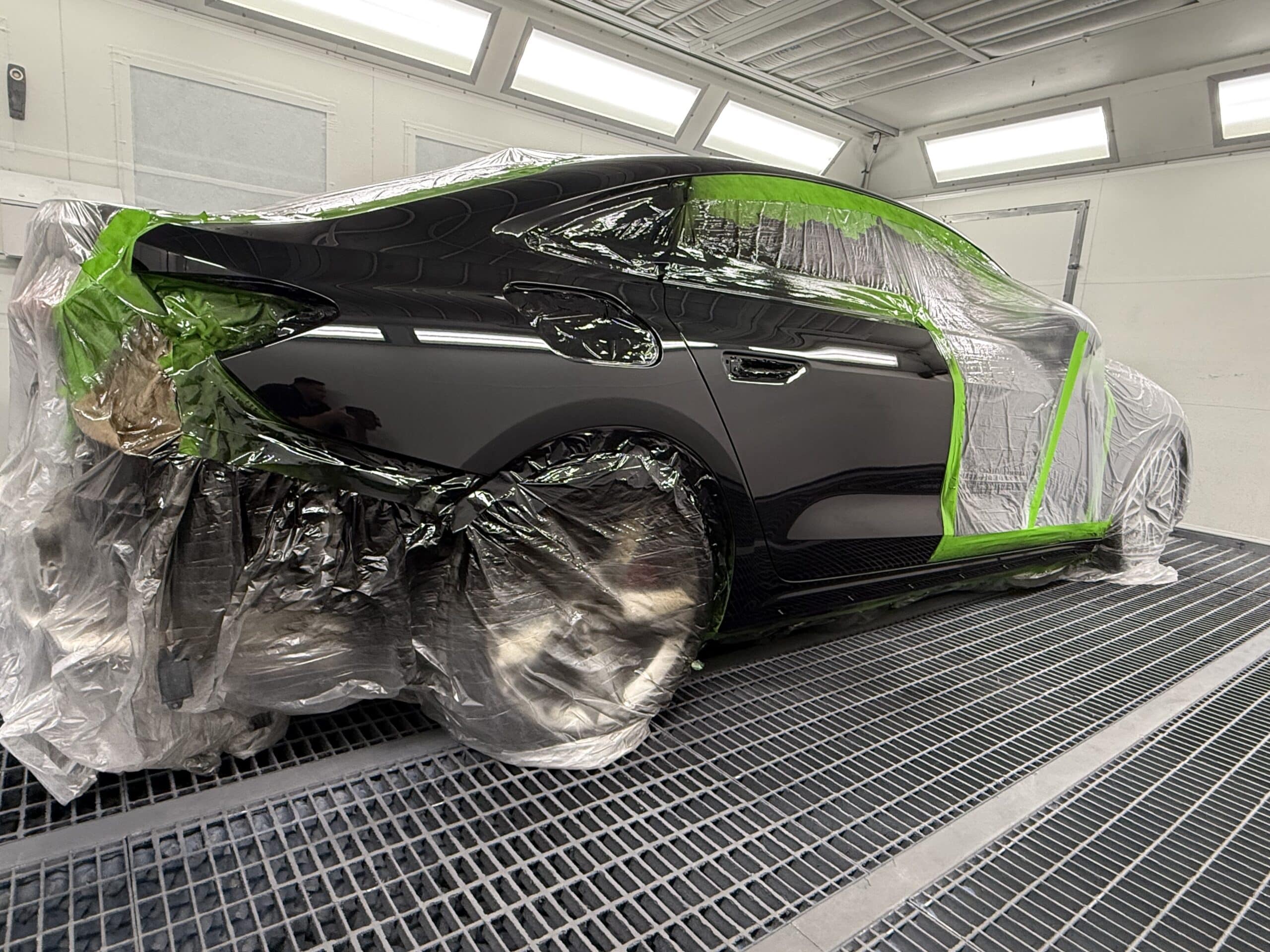 Technician inspecting a vehicle during the smash repair process.